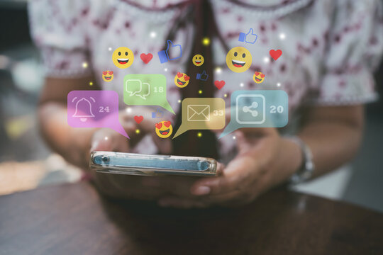 Woman using smartphone with floating social media icons. Concept of digital communication, online engagement, social networking, and modern lifestyle technology.