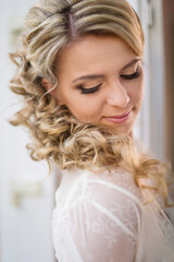Morning of the bride, getting ready, preparation. Wedding makeup and hairdo, makeup artist...