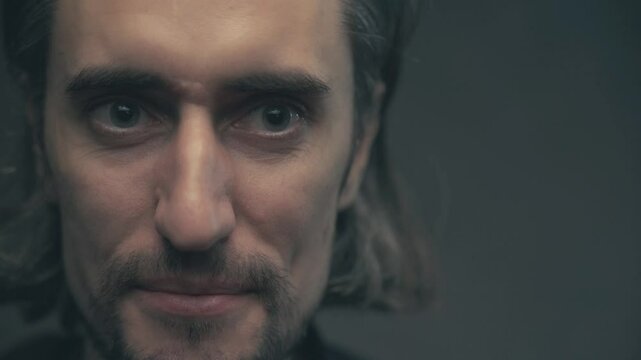 Close-Up of a Man's Evolving Facial Expressions: From Serious Contemplation to Subtle Smile