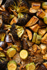 Oven-roasted vegetables: broccoli, zucchini, eggplant, and oyster mushrooms. Healthy, colorful dinner, perfect for family meals. Nutritious plant-based food, vegetarian cuisine