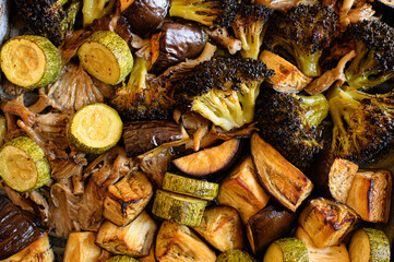 Oven-roasted vegetables: broccoli, zucchini, eggplant, and oyster mushrooms. Healthy, colorful dinner, perfect for family meals. Nutritious plant-based food, vegetarian cuisine