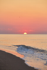 Obraz premium Sunrise Over Calm Ocean Waters