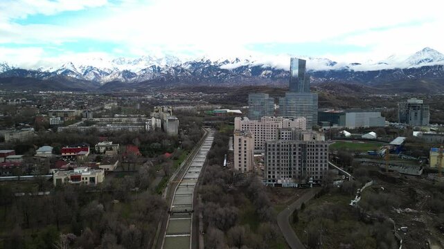 Almaty, Kazakhstan - 04.04.2025 : The river is in the center of the city. Different architecture. The view from the drone. Spring time.