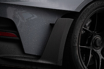 Close-up of a wet sports car in a dramatic setting