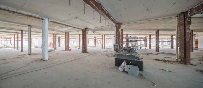 Renovation site with exposed beams and scattered materials