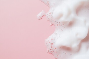 Fototapeta premium Beauty Product Foam Soap. Abstract background white soapy foam flowing texture. Shampoo foam with bubbles. Bubble surface isolated on pastel pink coral rose color. Suds. Facial cleanser. Froth Pattern