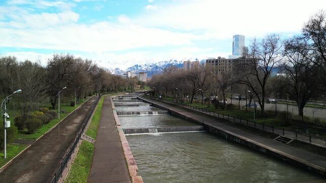 Almaty, Kazakhstan - 04.04.2025 : The river is in the center of the city. Different architecture. The view from the drone. Spring time.