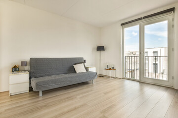 A bright and airy modern living room featuring a minimalist design. Large windows allow natural light to flood in, creating a welcoming atmosphere.