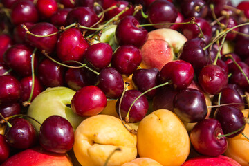 Close-up of fruits: apples, peaches, and sweet cherries