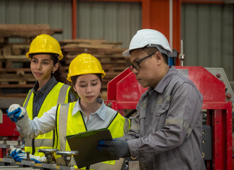 Leader manager talk work order staff male and female engineer technician team in hard hat discuss  working heavy machine new project business technology produc in workshop industry factory warehouse