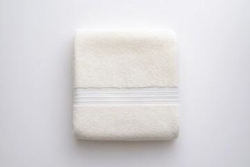 Soft white towel neatly folded with minimalistic design, highlig