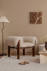 Cozy reading corner with a sculptural armchair, floor lamp, and wall art in earthy neutrals...