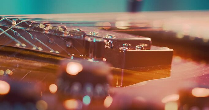 Close-Up of an Electric Guitar. Details of strings, frets, and the body shine under moody lighting. Music, creativity, and rock culture.