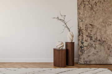 Two white ceramic vases with dried branches on fluted wooden pedestals in a serene minimalist corner. © FollowTheFlow