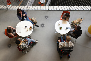 Disabled people talking at tables