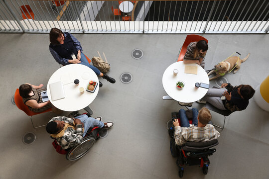 Disabled people talking at tables