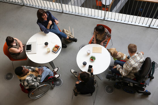 Disabled people talking at tables