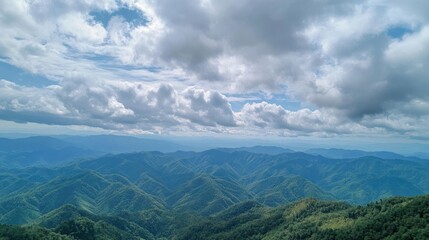 Obraz premium Scenic view of mountains with dramatic cloudy sky