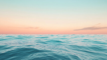 Calm ocean at sunset with pastel sky.