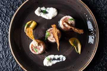 Jellied Seafood Appetizers in black plate on black background.