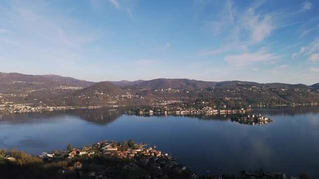 Pella village on Lake Orta in Northern Italy. Aerial drone ascending, copy space