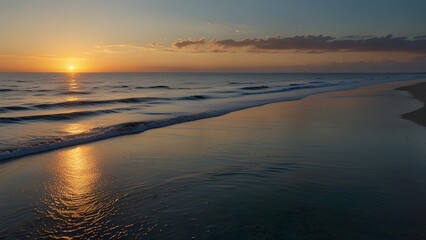   A calm ocean at sunrise with gentle waves lapping at the sh