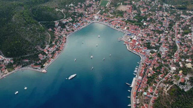 Panoramic drone shot of Vathy village in Ithaca island during sunrise, Ionian sea, Greece