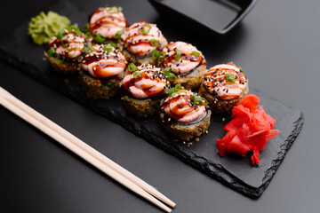 Delicious sushi rolls topped with creamy sauce and garnished for flavor