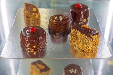 Chocolate and Hazelnuts Cakes at Silver Tray in Display Fridge