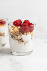 yogurt with granola and raspberries, breakfast