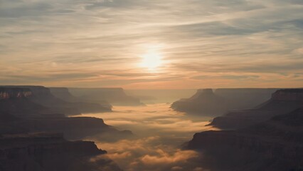 Fototapeta premium A tranquil landscape featuring smog gently creeping over hills at dusk, with a dim sun casting warm, high-contrast light over the serene scenery.