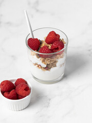 yogurt with granola and raspberries, breakfast