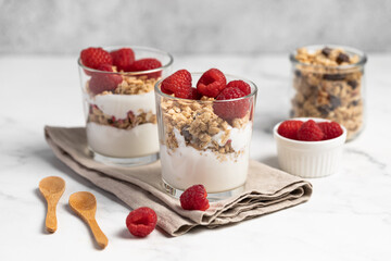 yogurt with granola and raspberries, breakfast