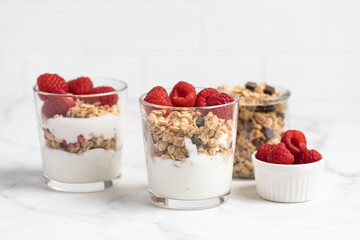 yogurt with granola and raspberries, breakfast