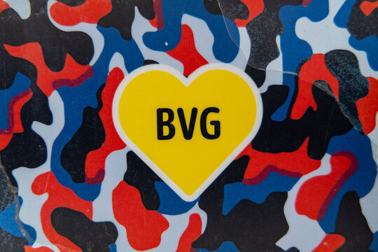 Germany Berlin April 7, 2025. Logo of public transport in Berlin BVG. Yellow heart with the letters BVG on it. Heart on blue, red and black background