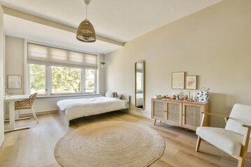 A bright and airy bedroom featuring a cozy bed, natural light from large windows, and minimalist decor for a tranquil atmosphere.