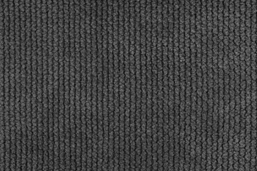 Texture of velour jacquard black fabric coarse weave close up, macro woven coarse. Textile background, furniture textile material, wallpaper, backdrop. Cloth structure close up, macro.