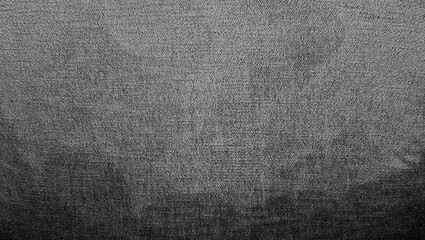 A close-up photograph showcasing the rich, vibrant texture of deep black or grey velvet fabric with a subtle gradient, suitable for use as a luxurious background or design element.