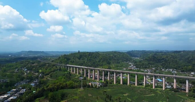 aerial view of train traveling in the spring green tea field at Sichuan China