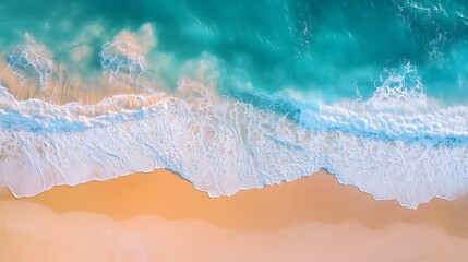 Fototapeta premium Aerial view of ocean waves crashing on sandy beach.