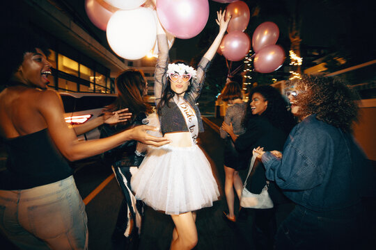 Group of young women celebrating a bachelorette party during a fun night out
