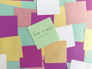 Colorful sticky notes with motivational message encouraging relaxation and rest during busy day