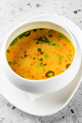 A steaming bowl of vibrant soup, featuring a blend of vegetables and herbs infused with rich flavors. This healthy dish is perfect for warming the soul and enjoying a comforting meal.