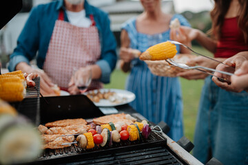 Close up of family preparing food for a spring weekend barbecue.