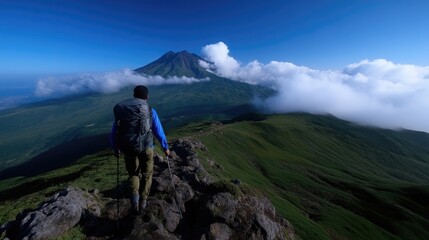 Fototapeta premium Hikers ascends mountain ridge with volcano in background. Vast panoramic view, fresh air, and serenity