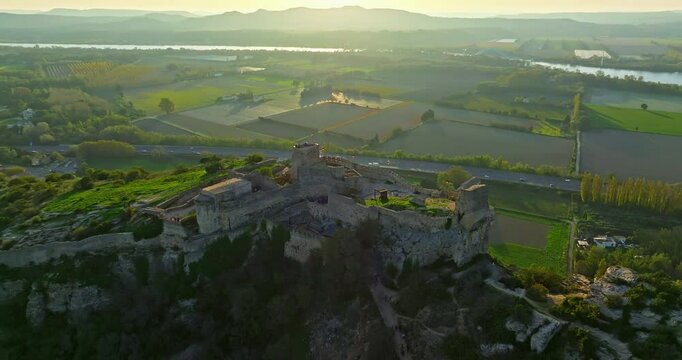 Mornas Fortress stands majestically on top of a rocky cliff. The Fortress of Mornas is a medieval fortress above the village of the same name in the French department of Vaucluse