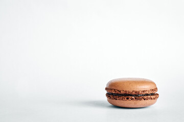 one brown macaron stack on gray background, chocolate flavor