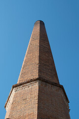 Brick chimney against blue sky	