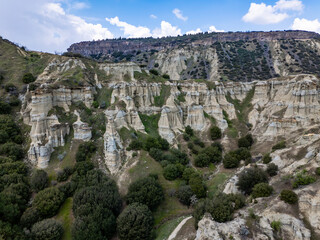 Obraz premium Aerial View Kula Geopark Fairy Chimneys Rising from Volcanic Rock Formations Under Cloudy Sky