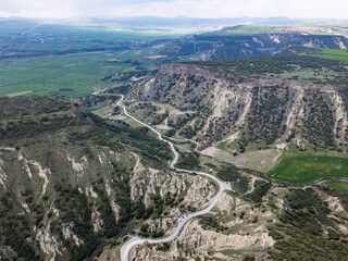 Fototapeta premium Aerial View Kula Geopark Fairy Chimneys Rising from Volcanic Rock Formations Under Cloudy Sky